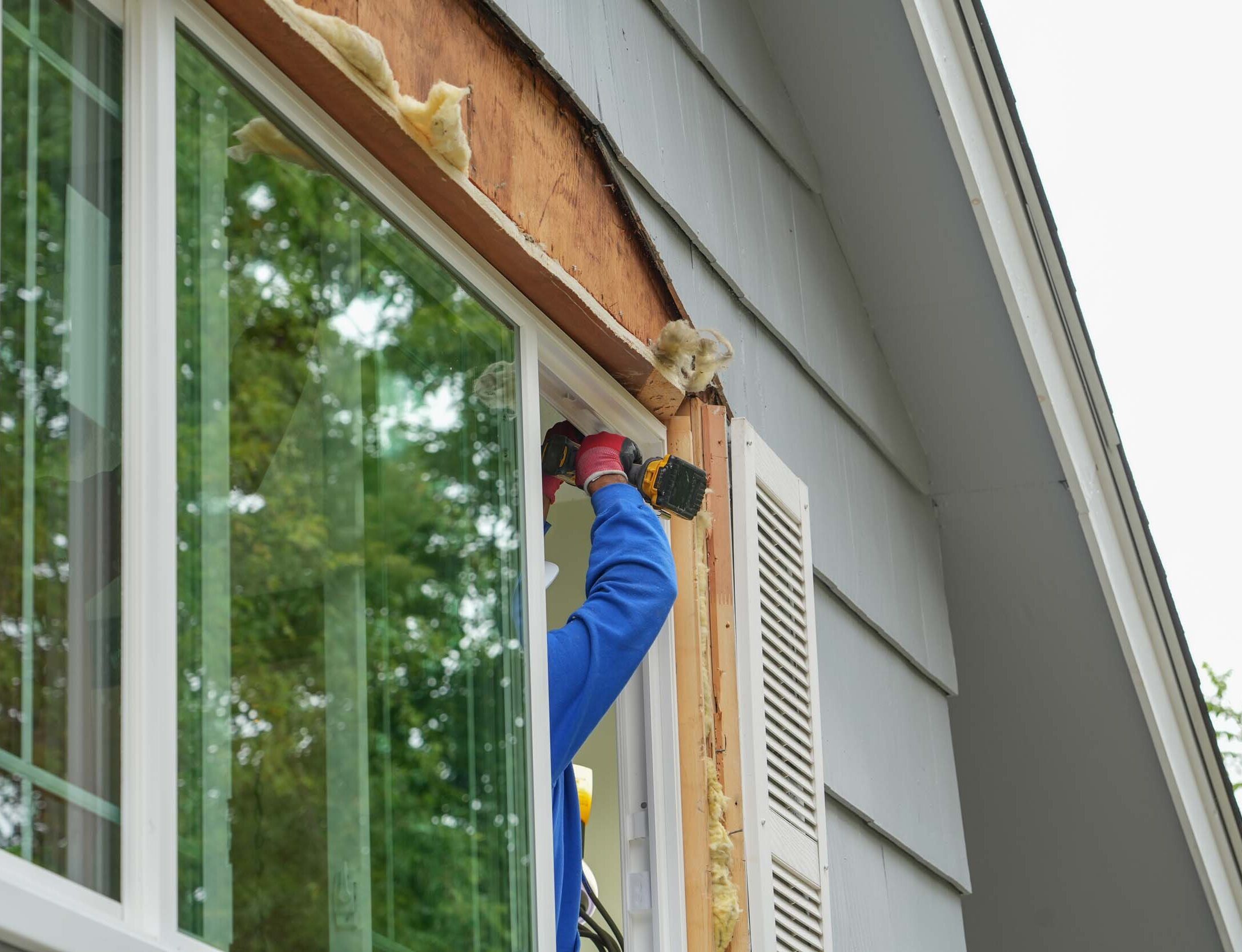 contractor working on replacing the window of the house
